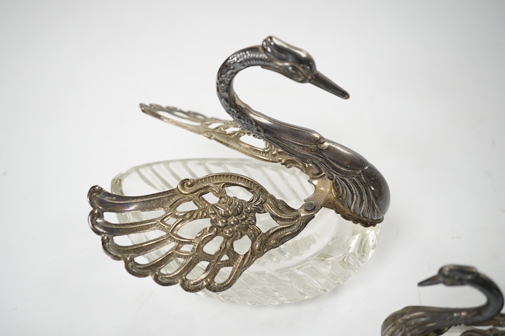 A graduated set of three silver mounted glass swan condiments, London, 1978, largest height 12.9cm. Condition - fair